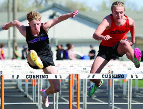 Mannford's Grant Pierce goes head to head with Cushing's Andy Collier in the 300m hurdles. Photo by Allie Prater